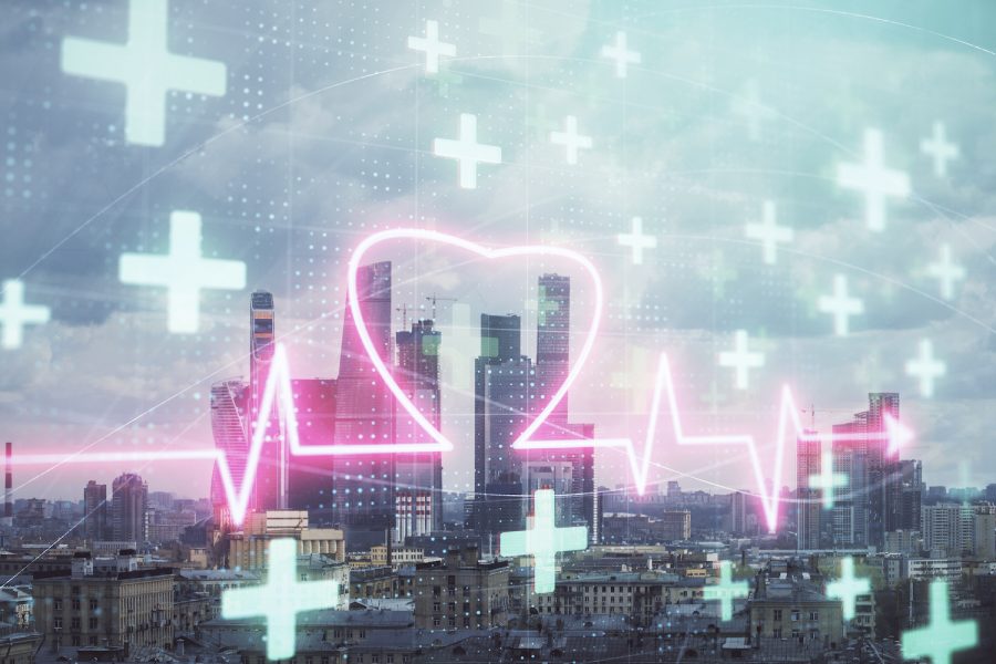 Multi exposure of human heart hologram on Moscow cityscape background. Concept of medical education